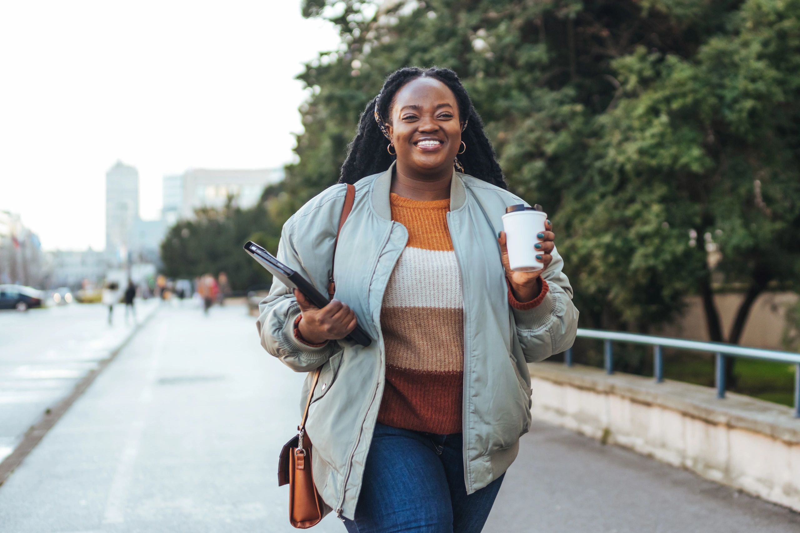 Commuter walking in the city with a coffee cup