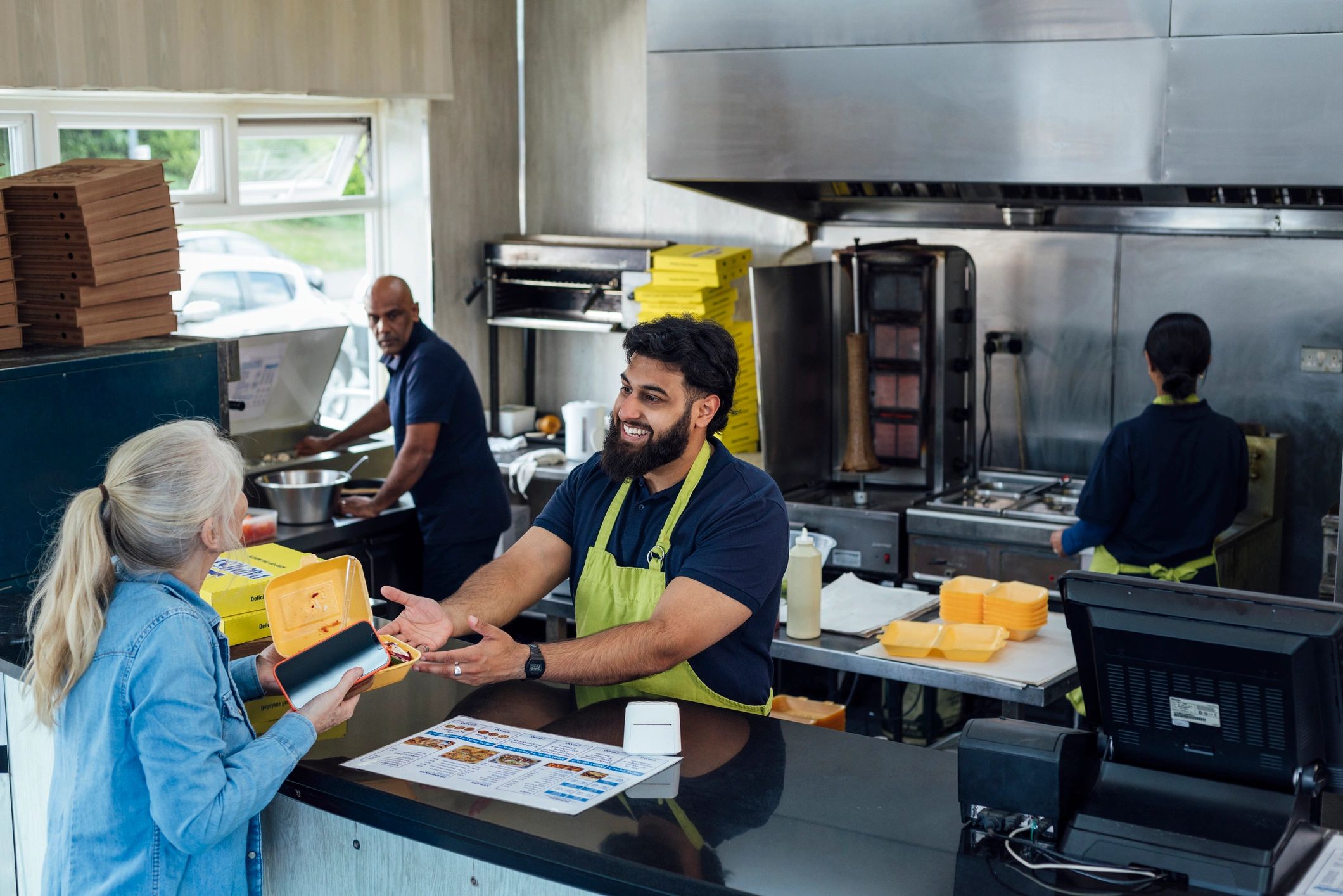 Takeaway counter handoff at a small shop